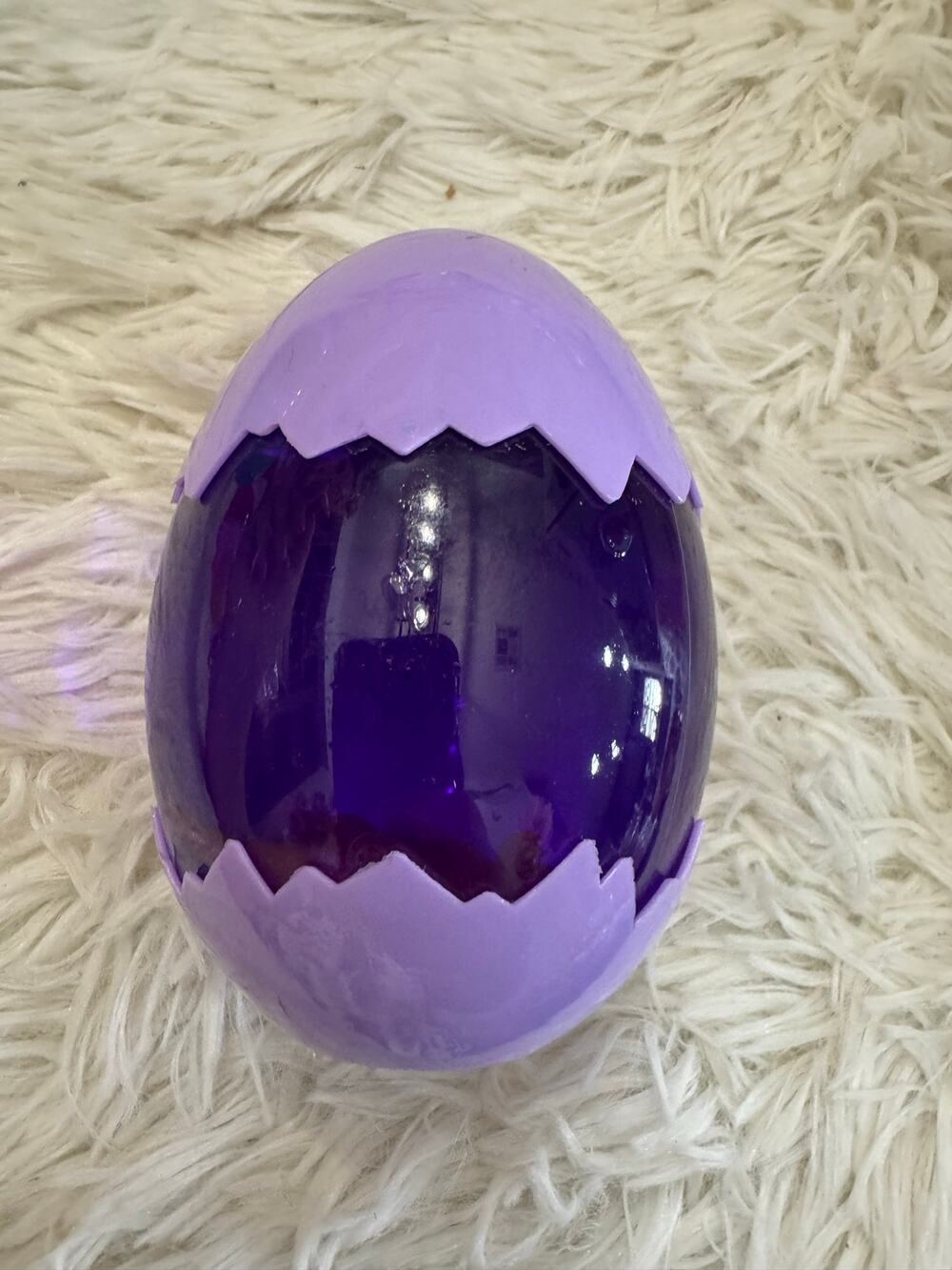 Purple slime dinosaur egg with an assorted dinosaurs inside